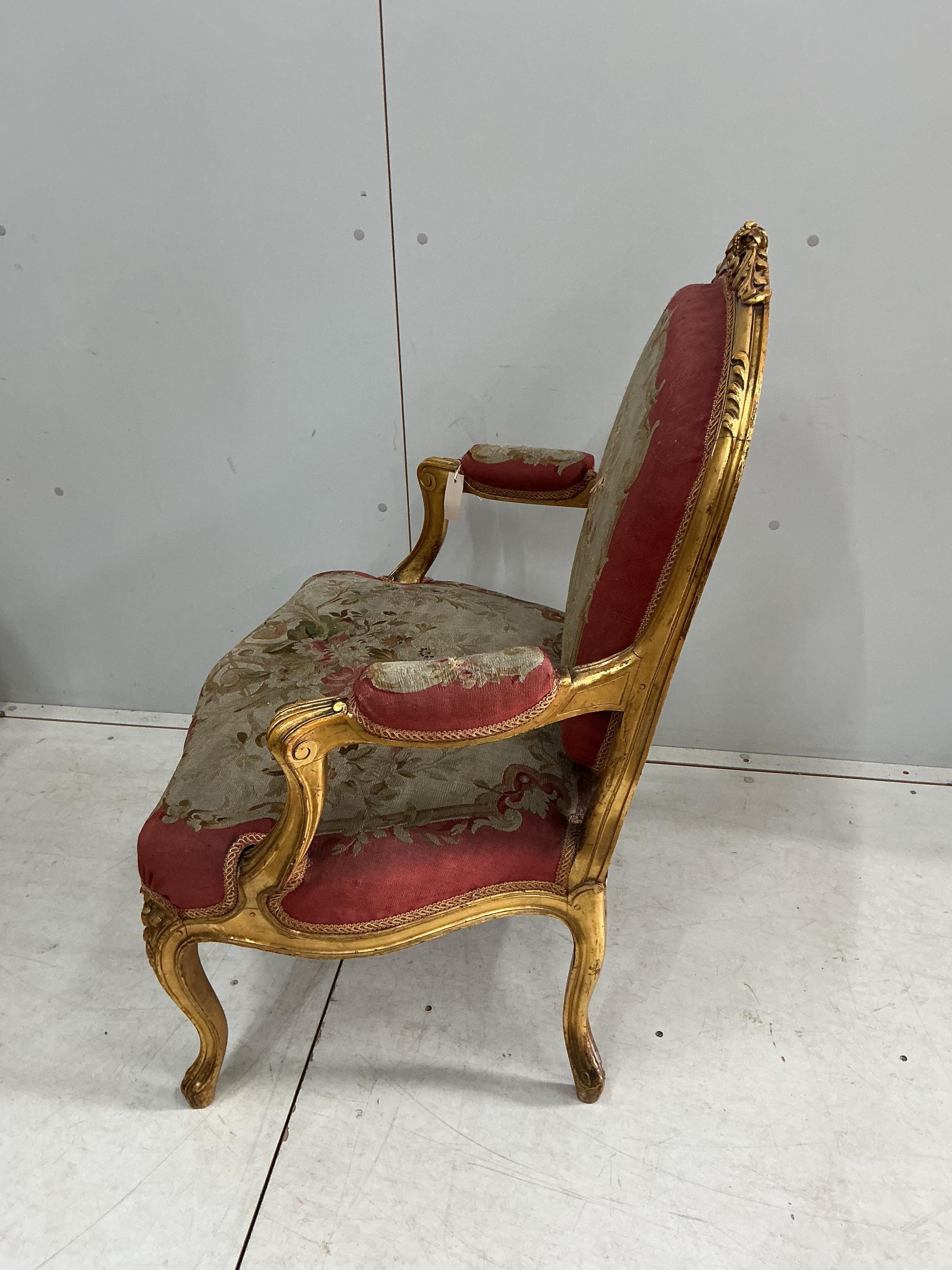 A pair of 18th century style giltwood and composition elbow chairs with petit point tapestry seats and backs, width 74cm, depth 52cm, height 96cm
